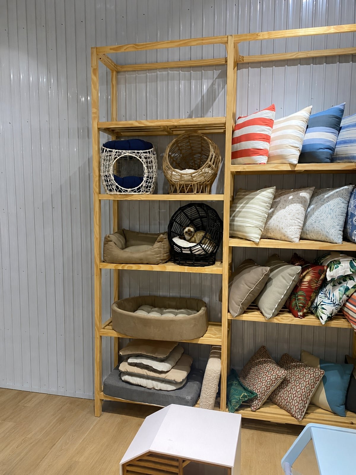 Shelving display of woven baskets and cushioned pet beds