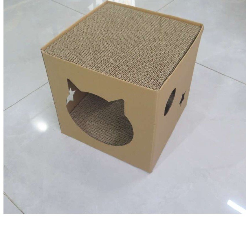 Foldable cardboard cat shelter with cat-shaped entrance and scratch top