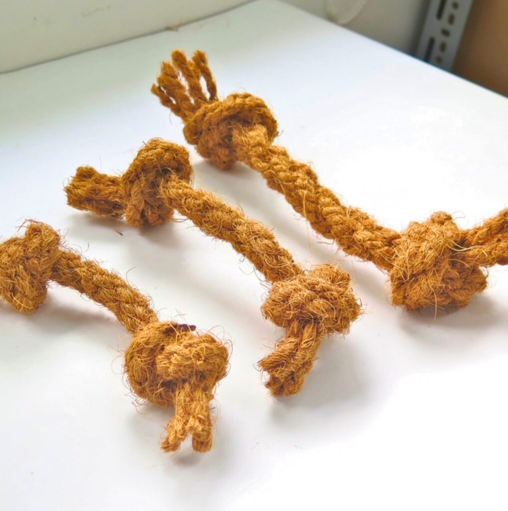 Three hand-braided coconut coir rope chew toys with knotted ends