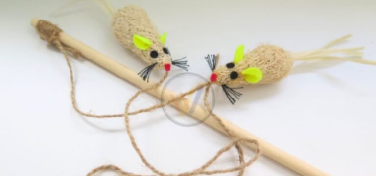 Two loofah fibre mouse toys with felt ears tied to a wooden cat wand